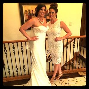 Off white lace dress with a tan bodice underneath.